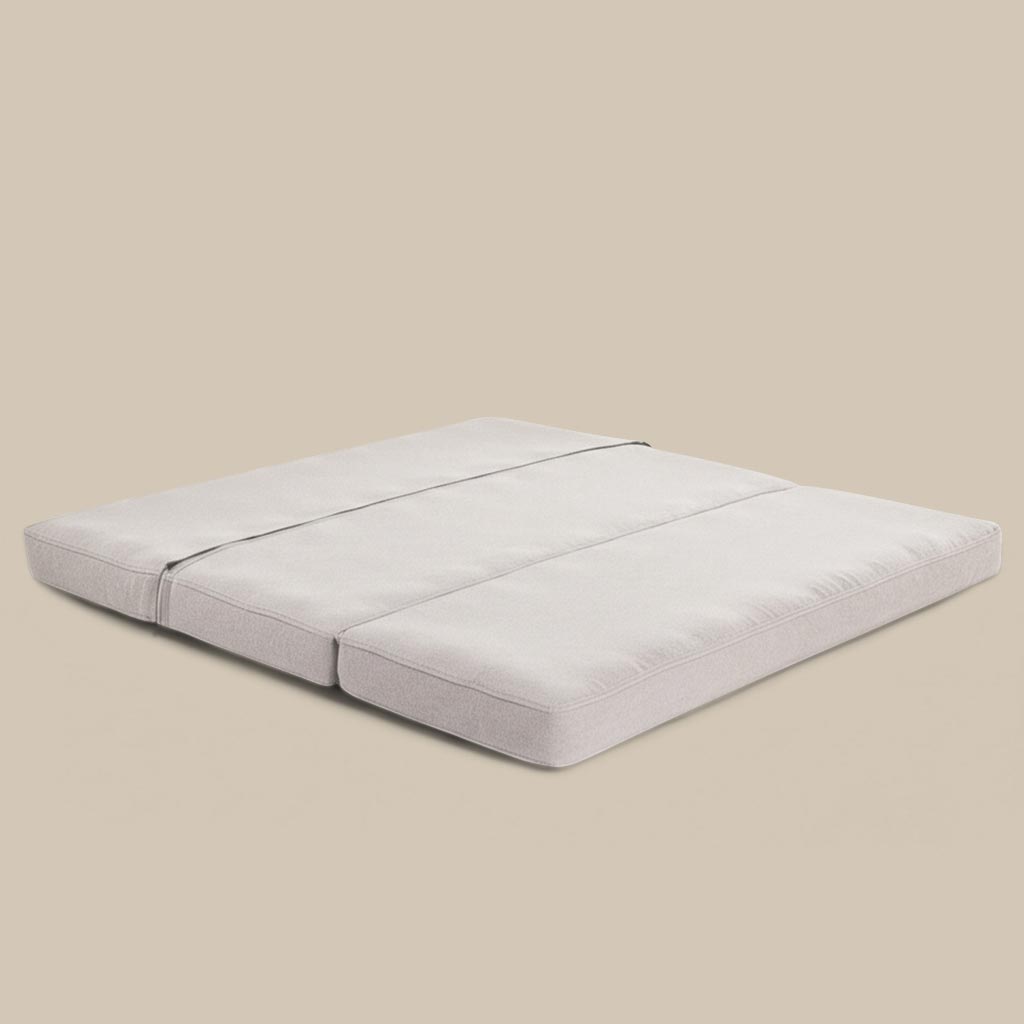 Foldable wool mattress laid flat, with three-section design and natural linen fabric