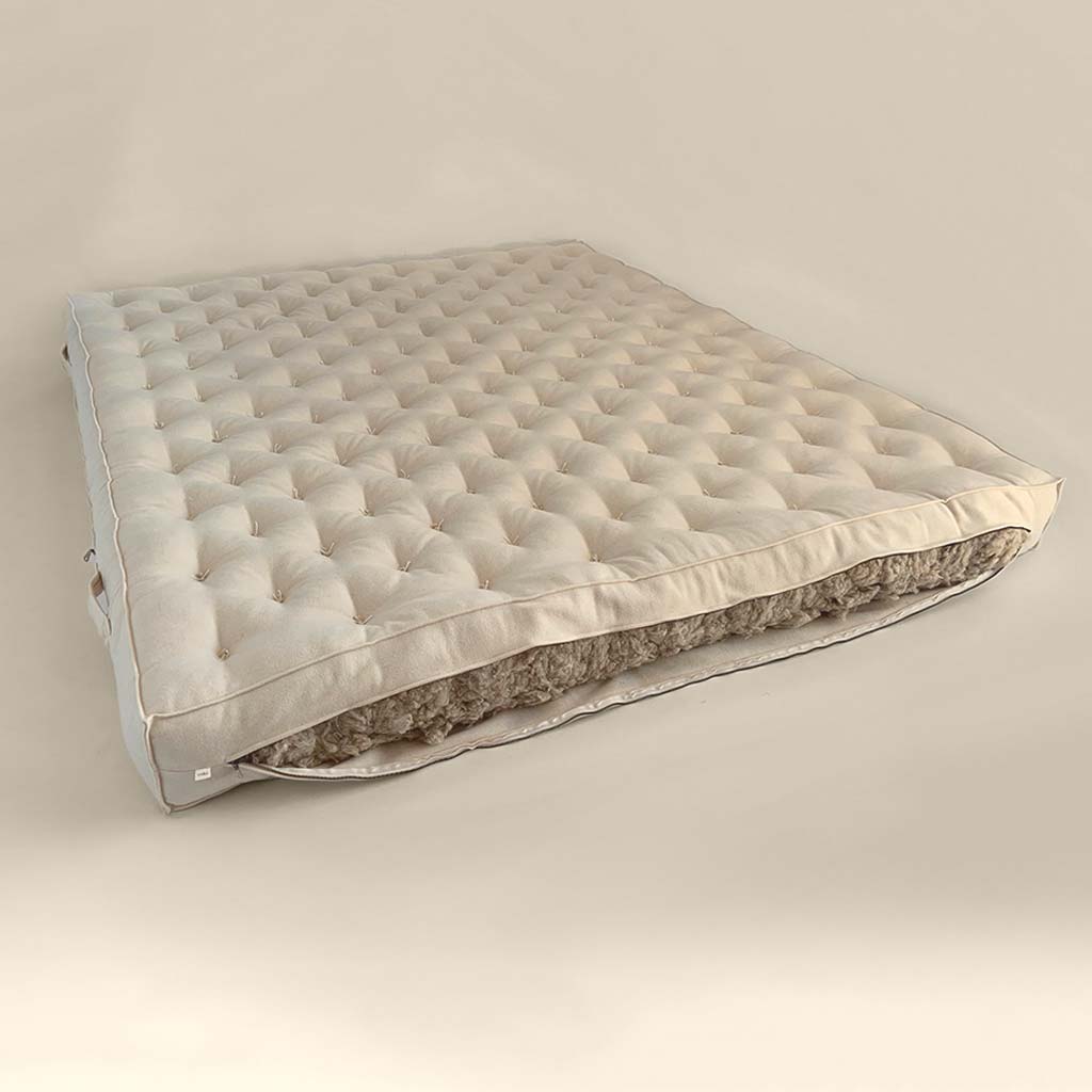 All-natural wool mattress with hand-tufted surface and visible wool filling cutaway