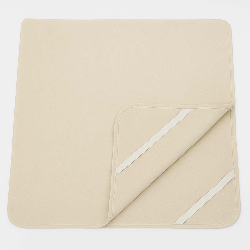 Natural wool mattress protector with elastic corner straps, breathable and chemical-free for added comfort and protection