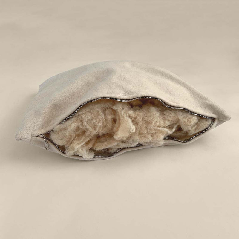 Natural wool pillow with zippered opening, showing breathable wool filling for adjustable, chemical-free comfort