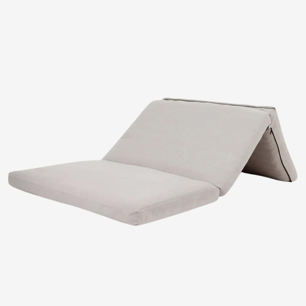 Foldable wool mattress with certified wool filling and natural linen cover, shown partially folded on neutral background.
