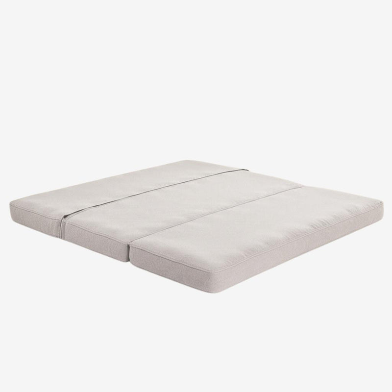 Foldable wool mattress laid flat, with three-section design and natural linen fabric.