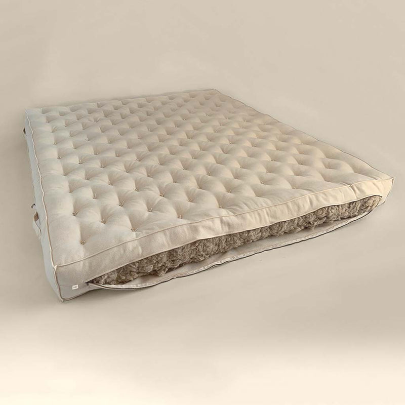 All-natural wool mattress with hand-tufted surface and visible wool filling cutaway