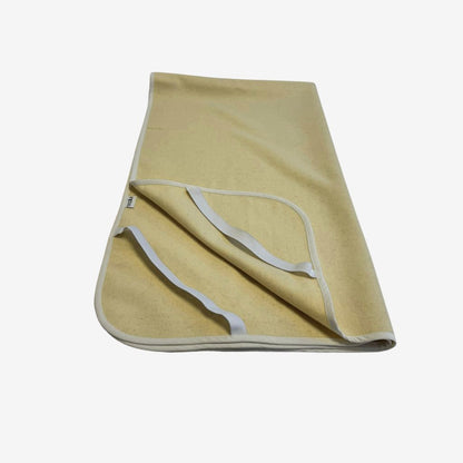 Natural wool mattress protector with elastic corner straps, breathable and chemical-free for added comfort and protection.