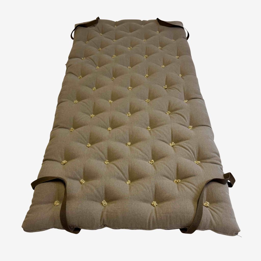 Brown linen wool mattress topper with diamond tufting and corner straps – full top view.