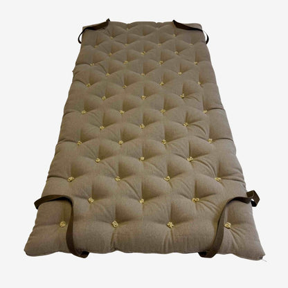 Brown linen wool mattress topper with diamond tufting and corner straps – full top view.